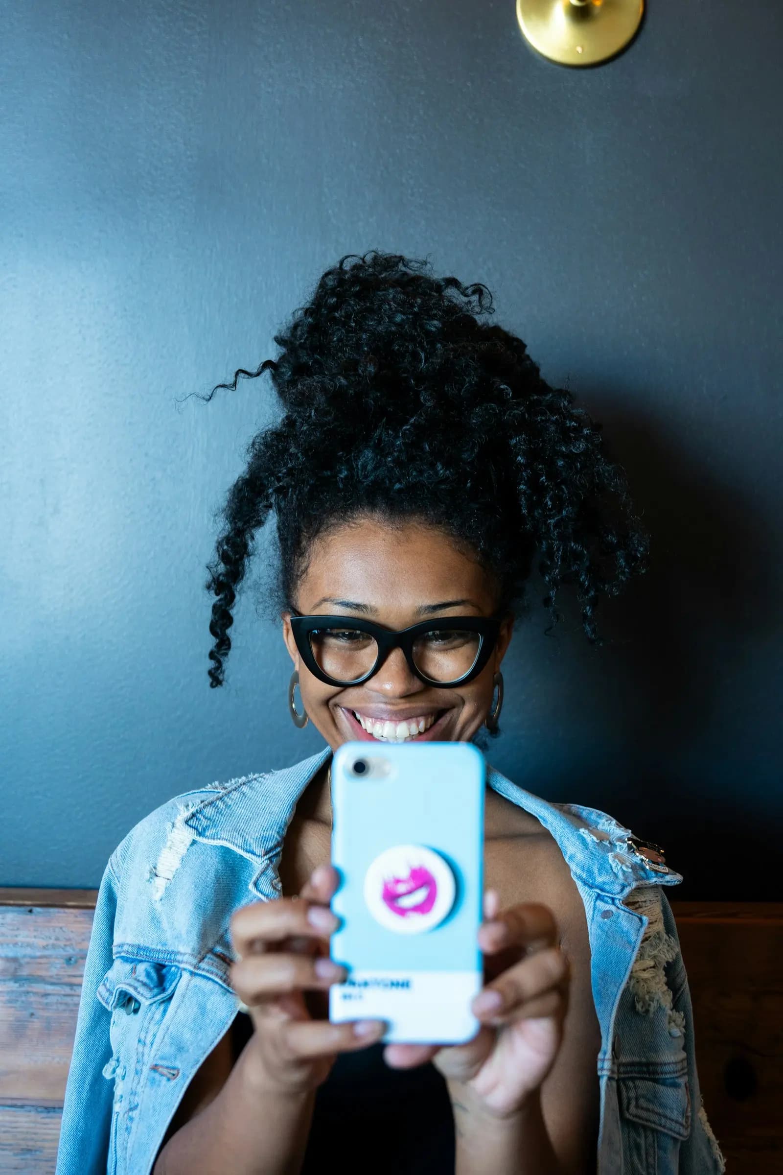 An employee smiling at her phone