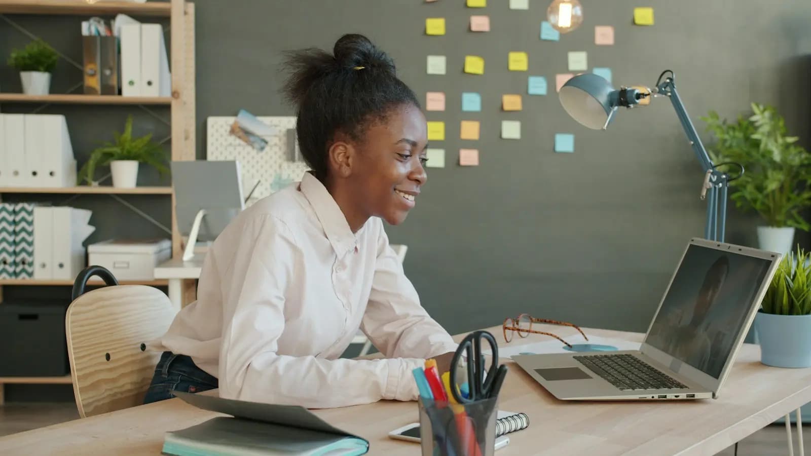 An HR officer smiling at her laptop