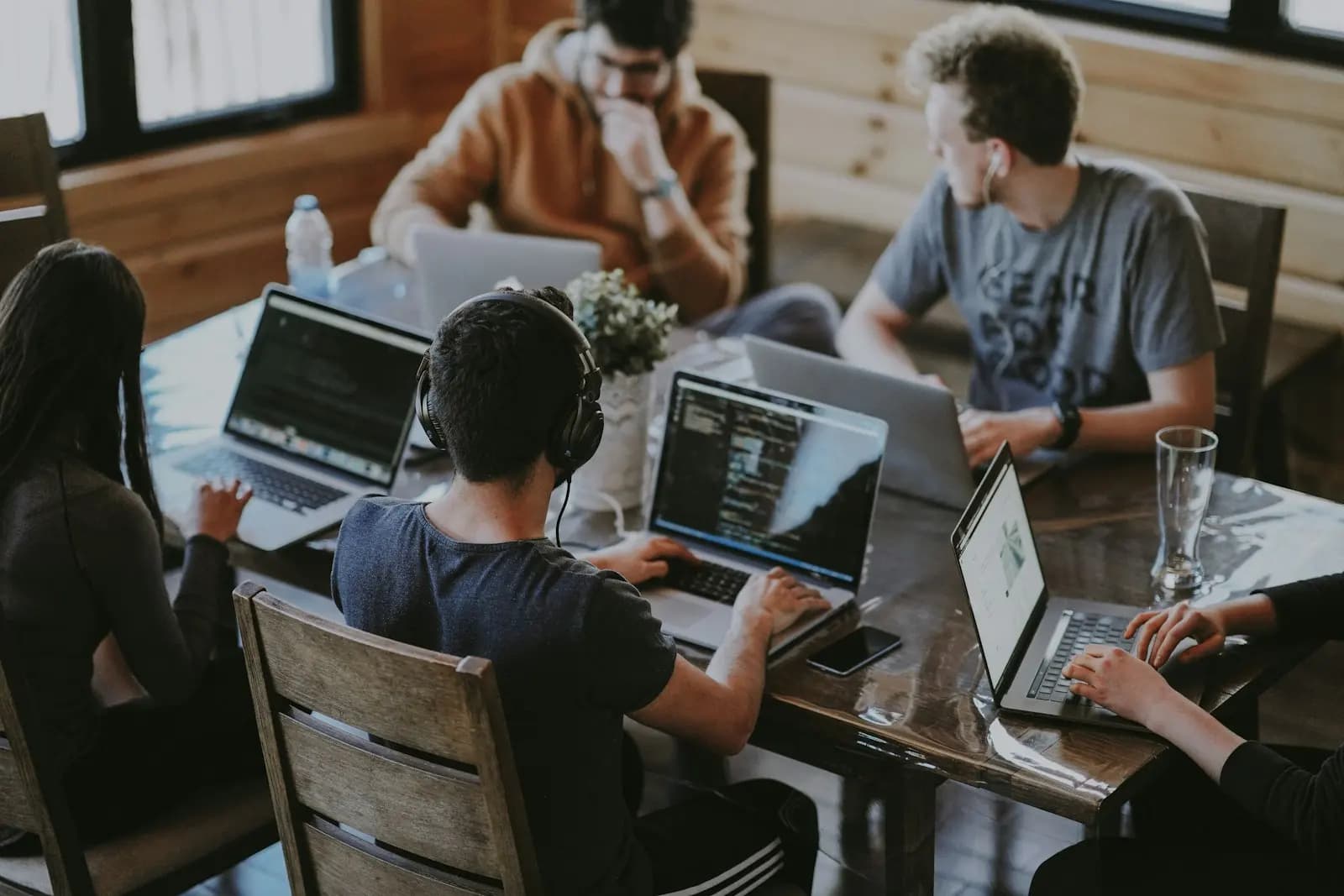 A team working on laptops around a table